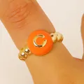 Macro view of a gold-beaded ring featuring a vibrant orange enamel letter C detail - English Letter C Ring (8992) / Orange
