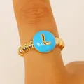 Macro detail of a gold beaded ring featuring a vibrant blue initial L centerpiece - English Letter L Ring (2717) / Sky Blue
