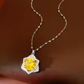 Close-up of shiny yellow zircon star pendant necklace resting on a leather background - Silver-Yellow
