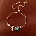 Elegant gold tulip bracelet featuring blue zircon petals and adjustable box chain - Tulip (HB5670) / Gold-Blue