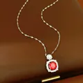 Detailed close-up of a silver necklace with a square pendant and round red zircon gem. - Red Main Stone (HN11761)