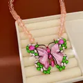 Macro detail of vintage beaded butterfly necklace with pink resin and green stones - Butterfly Necklace / Gold-Pink-Green