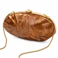 Detail of acrylic shell clutch bag featuring brown marble texture and golden metal frame - Dark Brown