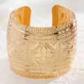 Macro shot of wide gold cuff bracelet featuring intricate geometric embossed textures - 07 Kc Gold 7049