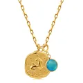 Macro view of Capricorn constellation coin and blue gemstone on 18k gold chain necklace - Capricorn