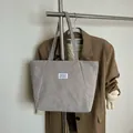 Light gray corduroy tote bag with fashion label and shoulder straps for daily use - Gray