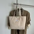 Minimalist beige corduroy tote bag with white rectangular label in a vintage style - Off White