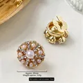 Luxurious gold round cufflinks with central pearl and micro crystals on marble, size 25mm - 25mm