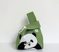 Detail of green knitted tote bag featuring a panda pattern and textured woven finish - Green - Rubbing Eye Panda