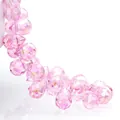 Macro detail of faceted pink teardrop crystal beads with sparkling light refraction - Pink AB / 6mm (approximately 87 Beads Per Strip)
