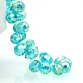 Macro detail of faceted cyan blue K9 crystal glass teardrop beads for jewelry making - Sea Blue AB / 6mm (approximately 87 Beads Per Strip)