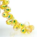 Macro detail of faceted yellow K9 crystal teardrop beads with iridescent AB coating - Bright Gold / 6mm (approximately 87 Beads Per Strip)