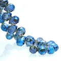 Macro detail of faceted deep blue K9 crystal teardrop beads arranged in an S-curve - Electroplated Dark Blue / 6mm (approximately 87 Beads Per Strip)