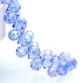 Macro view of blue faceted teardrop crystal beads with high-refraction sparkling finish - Light Blue Ab / 6mm (approximately 87 Beads Per Strip)