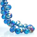 Macro shot of dark blue faceted K9 crystal teardrop beads with iridescent AB coating - 8mm (Approx 87 beads/string) / Peacock Blue AB
