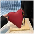Chic red heart-shaped handbag in lychee grain leather with colorful LOVE strap - Red