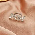 Silver butterfly open ring featuring sparkling crystals on a pink satin fabric - Two Butterflies Flying Open Ring (12423)