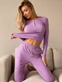 Close-up of purple ribbed lounge set showing white button details and knit texture - S / Purple