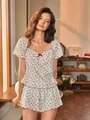 Close-up of floral pajama top with red bow and contrast piping on the square neck - S / White