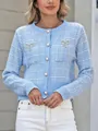Detailed view of light blue tweed knit cardigan featuring pearl buttons and rhinestone bows - S / Tops / Blue