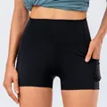 Women's black high-waisted yoga shorts with side pockets and slimming tummy control - XS / Bottoms / Black