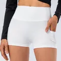 High-waisted white yoga shorts for women with side pockets and elastic fabric - XS / Bottoms / White