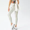Cream high waisted yoga pants with side pockets and a functional towel ring detail - S / Silver