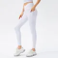 White high-waisted yoga pants with cross waist design and side pockets for fitness - S / Bottoms / White