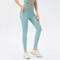 High-waisted light blue yoga leggings with crossover V-waistband and side pockets - S / Bottoms / Cloud Blue