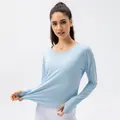 Women's light blue long sleeve sun protection shirt with thumb holes and UPF50+ stretch fabric - 2/XS / Tops / Light Blue