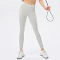 Light grey high-waisted yoga leggings with side pockets and slimming compression fit - 2/XS / Bottoms / Apricot Grey