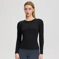 Haut de yoga noir à manches longues coupe ajustée en tissu extensible et respirant - Noir