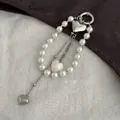 Elegant silver metal heart pendant bag chain with white pearls and stylish layered tassels - Heart Pearl Shell Style (0067) / Silver