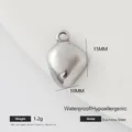 Macro view of a 15mm silver stainless steel heart pendant with precise measurements - Irregular Geometric Piece (003)