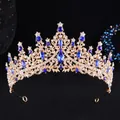 Detail of baroque gold alloy crown with large blue pear-shaped rhinestones and floral hollow design - Gold White Royal Blue