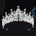 Close-up of silver bridal crown featuring green gemstones and sparkling white rhinestones - Silver White Dark Green