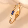 Detail of 18k gold plated titanium steel bracelet with blue enamel and crystal inlay - Sapphire Blue Shell