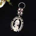 Detail of wooden angel keychain with pink beads and Spanish guardian angel engraving - Angel Girl Pink