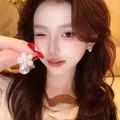 Elegant white flower stud earrings with hanging pearl drop on female model ear - White Five-Petal Flower Artificial Pearl Drop Style (E7060 Gold) / Gold