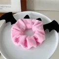 Pink plush scrunchie with black bat wings design for Halloween and festive hair styling - Pink Bat