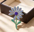 Macro detail of high-end floral brooch with sparkling blue and green crystal rhinestones - Blue Daisy Style