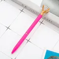 Elegant rose pink crystal diamond ballpoint pen with a gold claw-set top on a desk - Light Rose Pink (Rose Gold Parts)
