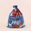 Close-up of Christmas gift bag with satin drawstring and festive winter town print - Red House / 44x57cm