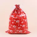 Detail of red Christmas drawstring gift bag with white snowflakes and HO HO HO text design - Large HoHo / 53x70cm