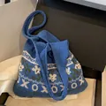 Blue knitted shoulder bag with white floral patterns and pearl embellishments - Pearl Lettering / XO Blue