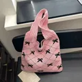 Pink knit tote bag featuring black bow patterns and vintage textured mesh design - Bow Decoration / Bowknot Pink
