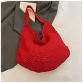 Bright red knitted hobo shoulder bag with hollow mesh texture on a gray suit background - Hollow Hobo / 609 Red