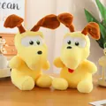 Pair of yellow plush Odie dog dolls with big eyes and floppy ears on a wooden desk - Pluto 30 Cm / Price And Color Are Random For Single Pieces Around 40cm In Length.