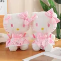Pink plaid dress Hello Kitty plush toy in 40cm sitting on a wooden surface - 30cm Hello Kitty With Bow / Price And Color Are Random For Single Pieces Around 40cm In Length.