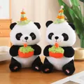 Pair of panda plush toys wearing green party hats and holding red cakes on a table - Small